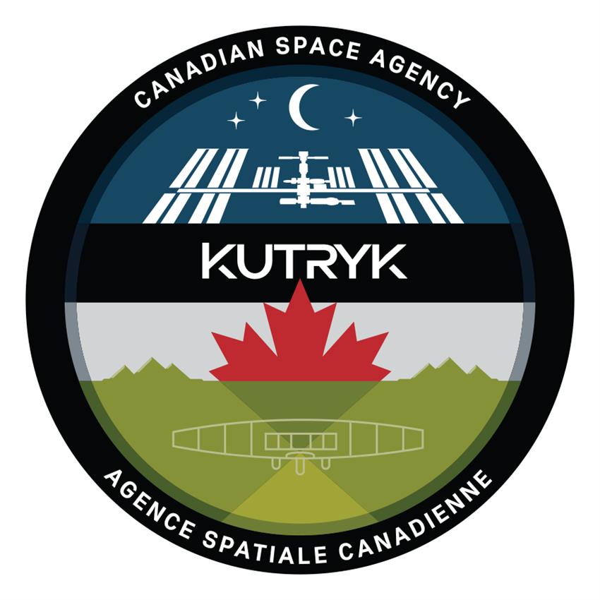 A circular patch featuring various elements from space and from Earth, the name Kutryk is written in the middle.