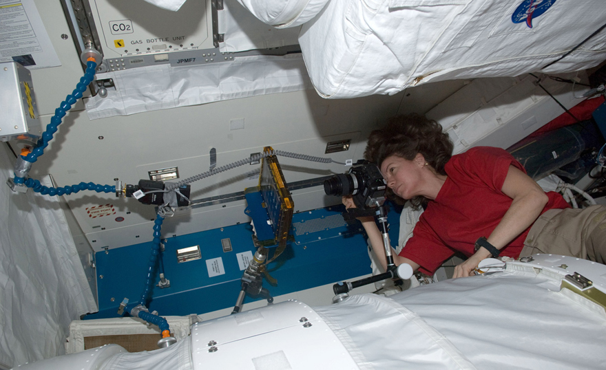 Photo of NASA astronaut Catherine Coleman takes a photo of the BCAT-5 hardware